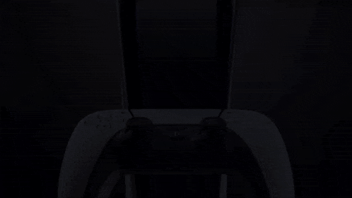 a close up of a playstation controller against a dark background