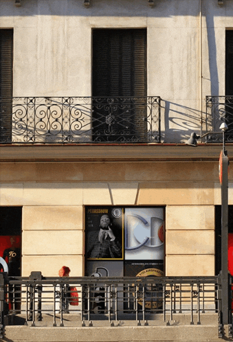 a building with a balcony and a poster that says ' plazashow ' on it