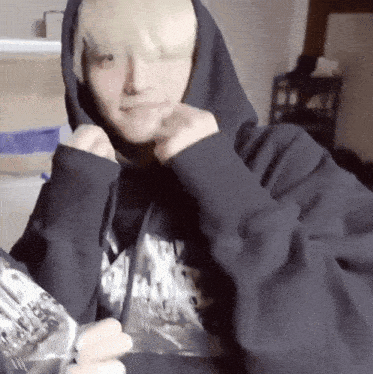 a person wearing a black hoodie with the word rocker on the sleeve