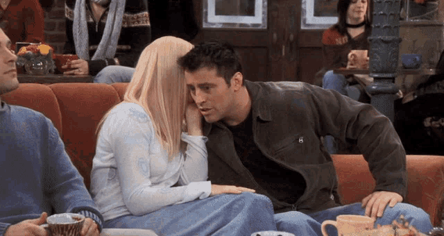 a man and a woman are sitting on a couch in a room