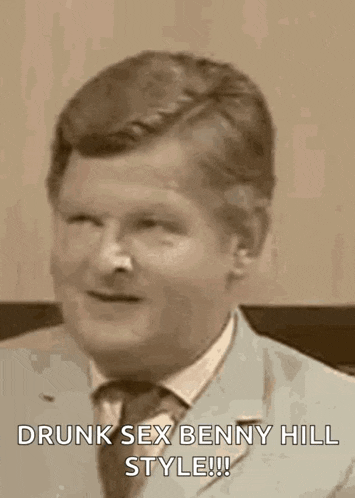 a man in a suit and tie is sitting in a chair .