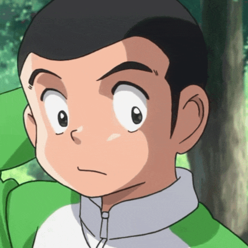 a close up of a boy 's face with a green shirt on