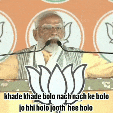 a man is giving a speech in front of a lotus symbol
