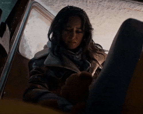 a woman is sitting in a dark room with a y4sgp watermark