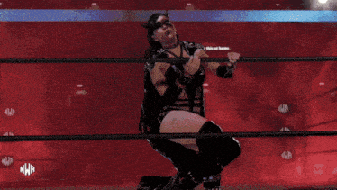 a woman in a wrestling ring with the letters nwp on the bottom