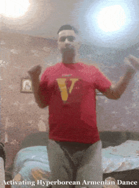 a man wearing a red shirt with the letter v on it is dancing