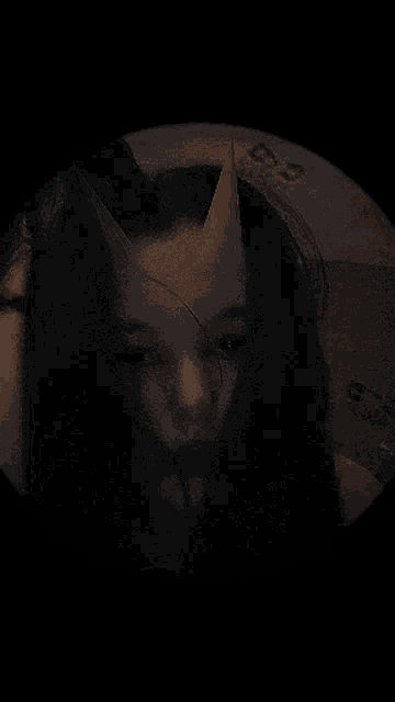a girl with horns on her head looks at the camera