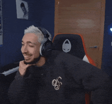 a man wearing headphones and a sweater that says n on it