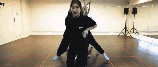 a group of girls are dancing in a dance studio .