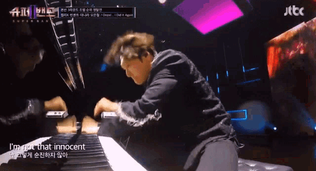 a man playing a piano with the words i 'm not that innocent on the bottom right