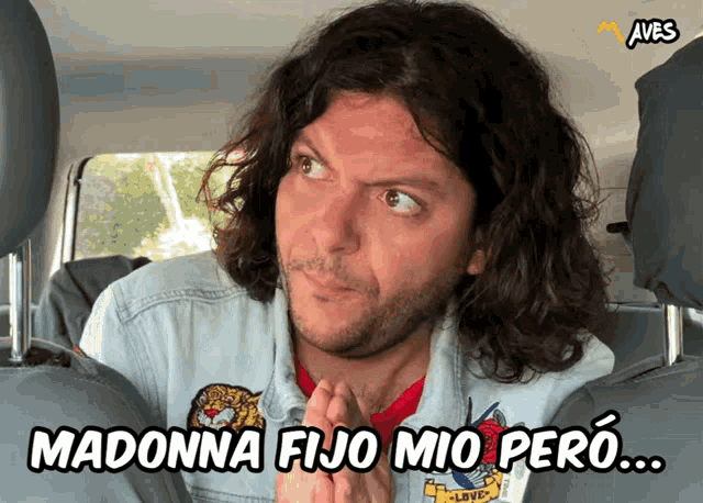 a man in a car with the words madonna fijo mio pero written above him