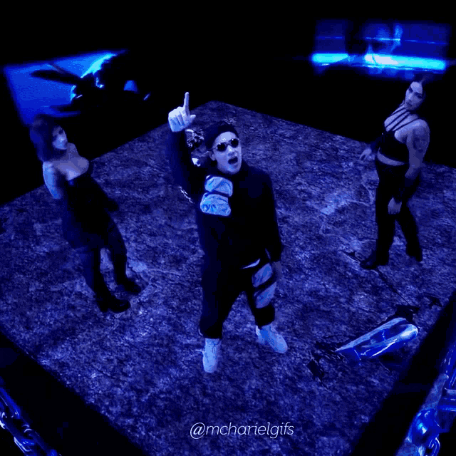 a man and two women are dancing in a dark room with the hashtag @mchartelgifs on the bottom