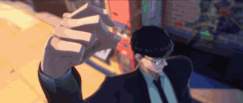 a man in a suit is holding a cigarette in his hand