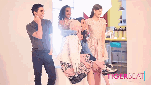 a group of people standing next to each other with the word tigerbeat on the bottom right