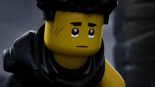a close up of a lego character 's face with a sad look on his face