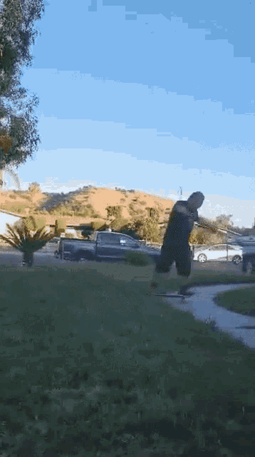 a man is riding a skateboard down a sidewalk in front of a truck