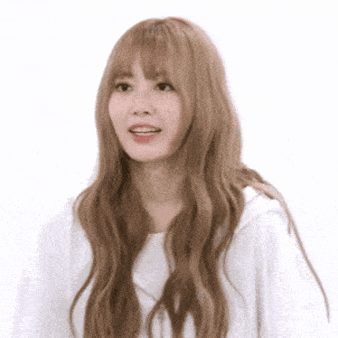 a woman with long blonde hair and bangs is wearing a white shirt