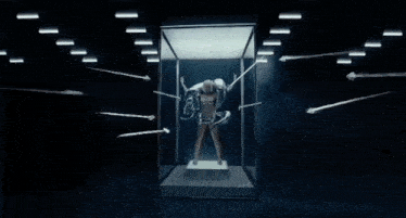 a woman is surrounded by arrows and ropes in a room