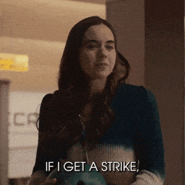 a woman is holding a bowling ball and talking about getting a strike .