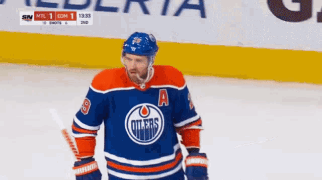 an edmonton oilers hockey player is standing on the ice