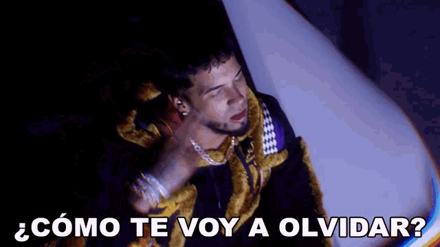 a man in a black and gold jacket is laying down with the words " como te voy a olvidar " above him