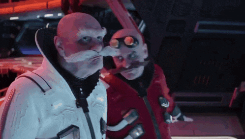 a bald man with a fake mustache and goggles stands next to another bald man with a fake mustache and goggles