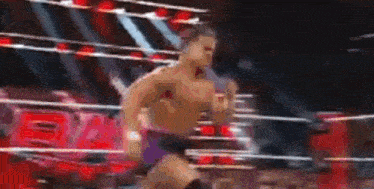 a blurred image of a wrestler in a ring .