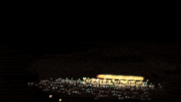 a blurry picture of a dark room with a few lights
