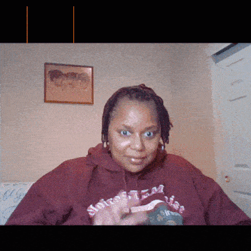 a woman wearing a maroon sweatshirt that says noises against