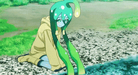 a girl with long green hair is sitting on the ground near a body of water .