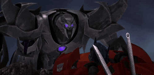 a transformer with purple eyes is standing next to a red vehicle