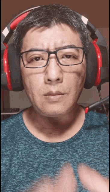 a man wearing glasses and headphones looks angry