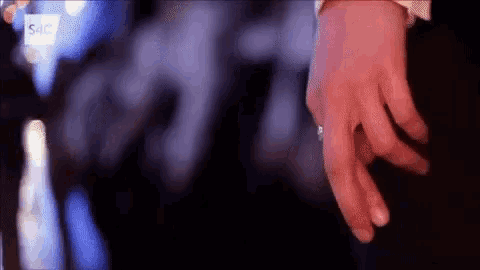 a close up of a person 's hands with a ring on their finger
