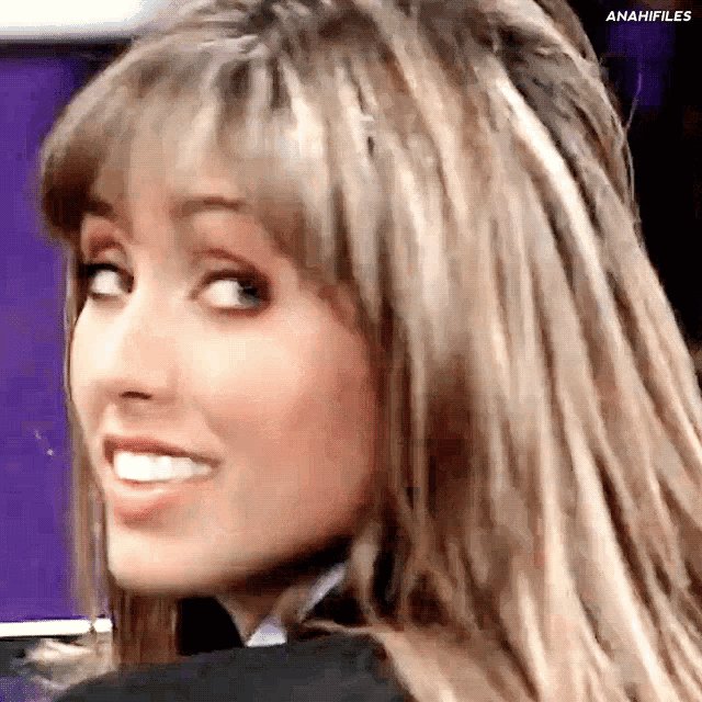 a close up of a woman 's face with a purple background that says anaifiles on it