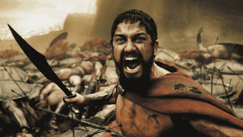 a man with a beard is holding a sword and yelling