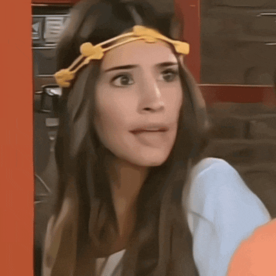 a woman with a yellow headband on her head looks surprised