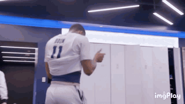 a man in a white shirt with the number 11 on the back