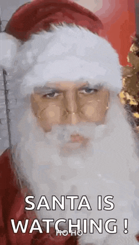 a close up of a man dressed as santa claus with a beard and hat .