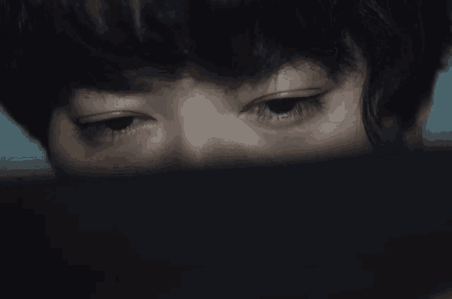 a close up of a person 's eye with blue eyes
