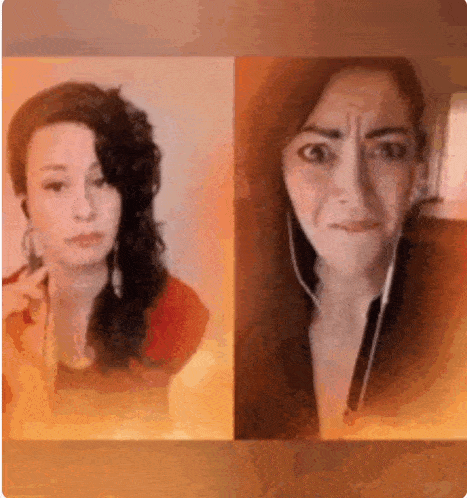 two women are standing next to each other and one of them is wearing headphones