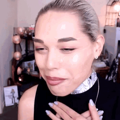 a woman with a scarf around her neck is making a face
