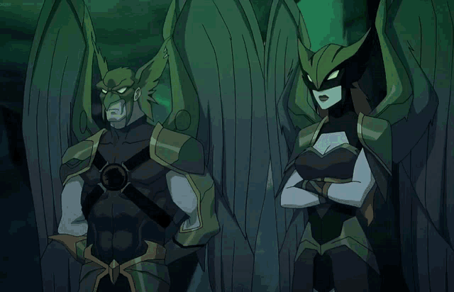 a man and a woman with green wings are standing next to each other with their arms crossed