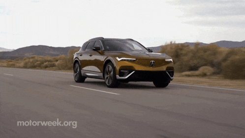 a car is driving down a road with a motorweek.org logo in the corner