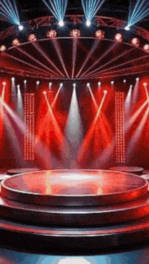 an empty stage with red lights and a round stage in the middle .