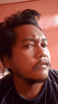 a close up of a man 's face against a pink background