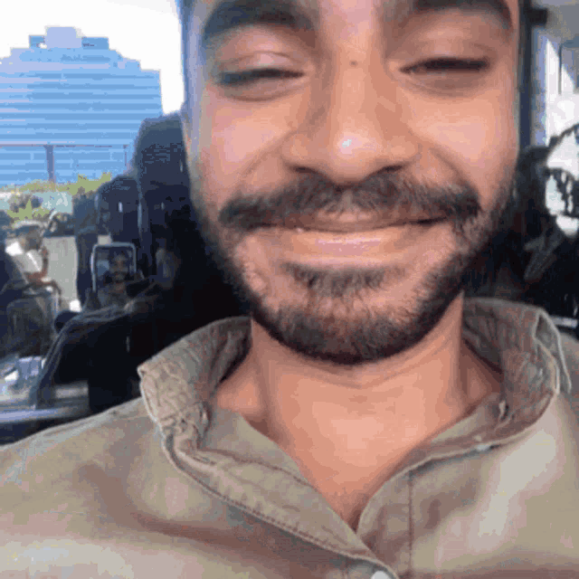 a man with a beard and mustache is smiling