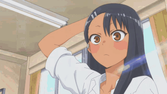 a girl with long black hair is holding her hand to her forehead