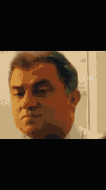a close up of a man 's face with the word tage visible
