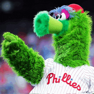 a mascot for the phillies is wearing a white and red striped jersey
