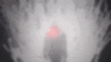 a blurry picture of a person with a red light in the background
